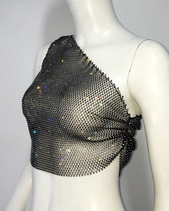 Detail of sparkly rhinestones on black mesh one-shoulder cropped top with metal chain links