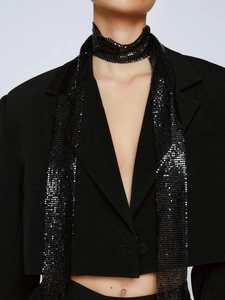 Detail of a chic black sequined metal mesh scarf necklace with a glittering finish