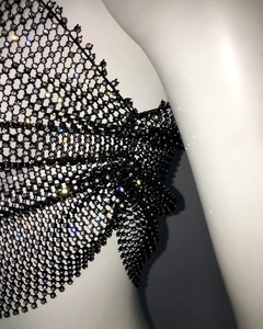 Close-up of black mesh body chain with sparkling rhinestones on mesh intersections