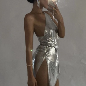 Detail shot of silver metallic sequin halter dress with high slit and plunging neckline
