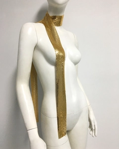 Close-up of golden metallic sequin mesh scarf featuring high-shine aluminum grid texture