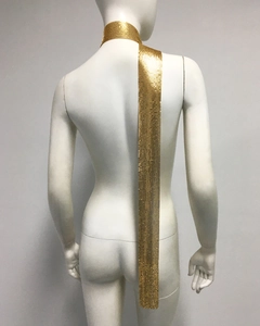 Detailed view of handmade golden metal mesh scarf with shimmering sequins and soft drape
