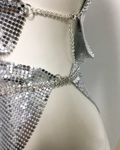 Close-up of silver metal sequin mesh dress with sparkling rhinestone chain trim and lobster clasp