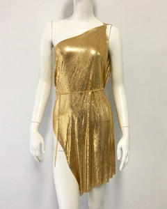Detail of the golden metallic mesh fabric and sequin texture on a one-shoulder dress