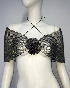 Detail of black fishnet crop top with sparkling rhinestones and a central mesh flower