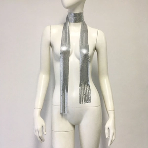 Detail of silver metallic sequin mesh scarf with tassel fringe on a display mannequin