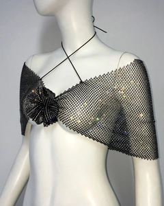 Close-up of black fishnet camisole top with sparkling rhinestones and a central fabric flower