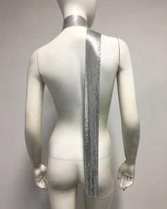 Detail of a long silver metal mesh sequin scarf draped over a mannequin's back