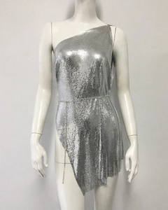 Detail of silver metallic mesh dress with rhinestone chain and asymmetrical hemline