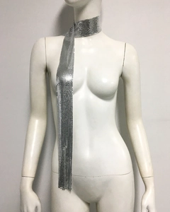 Detailed view of silver metallic sequin scarf with shiny mesh texture on a model