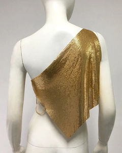 Détail du haut à paillettes dorées avec ourlet asymétrique en maille métallique au dos