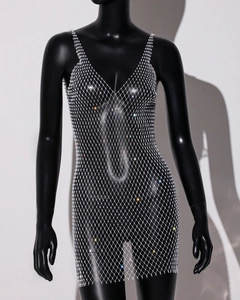 Detail of silver rhinestone mesh dress showing crystal embellishments on sheer fabric