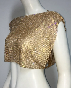 Close-up detail of golden metal mesh crop top featuring sparkling sequins and rhinestones