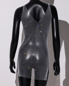 Macro detail of sparkling rhinestones on silver mesh see-through dress with deep V back