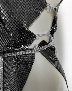Detail of black metallic sequins with silver chains and rhinestones on the mini dress
