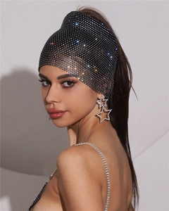 Gros plan d'un foulard en maille de strass étincelants et de boucles d'oreilles en cristal