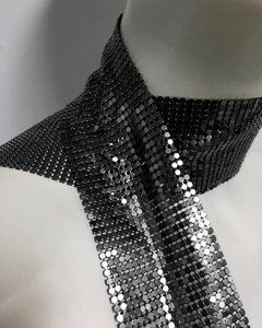 Detail of dark grey metallic mesh scarf featuring shimmering hexagonal sequins on a mannequin