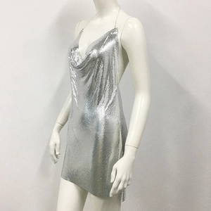 Detail of silver metallic sequin dress featuring side slits and mesh reflective texture