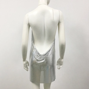 Detail of silver metallic mesh dress featuring backless design and chain halter neck
