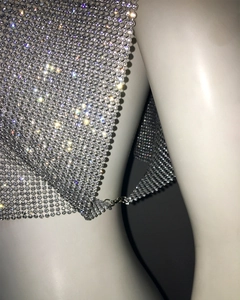 Detailed macro view of sparkling silver sequin mesh fabric with rhinestone inlay
