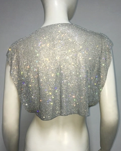 Detail shot of shimmering silver metal mesh top featuring sparkling rhinestone embellishments