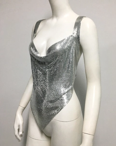 Detail of silver metallic mesh top with deep V-neck and sparkling sequin texture for parties
