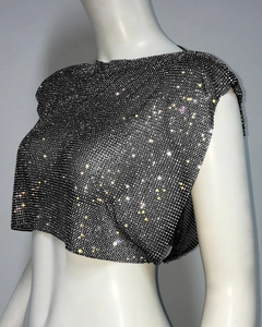 Detail of sparkly black metal mesh crop top with white rhinestones on a white mannequin