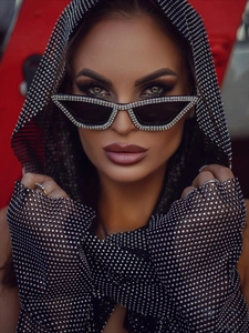 Detail of sparkly black rhinestone mesh hood and matching crystal-studded cat-eye sunglasses