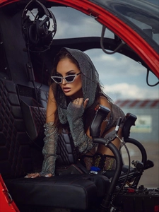Close-up of sparkling rhinestone mesh hooded sleeves set inside a helicopter cockpit