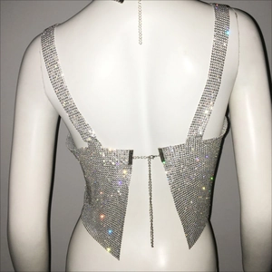 Détail du haut en strass argenté avec design dos nu et fermeture par chaîne en métal