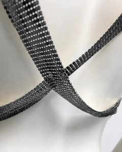 Macro view of metallic silver mesh sequins with reflective industrial grid texture