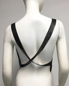 Detail of the back cross straps and shimmering black metal mesh texture on the sequin top