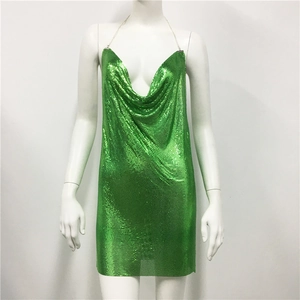 Detail of bright green metal sequin dress with chain straps and cowl neck draping