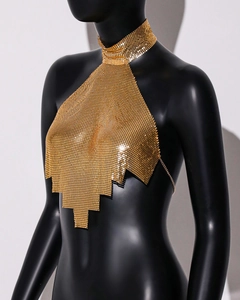 Close-up of gold metal sequin halter neck top with triangular chainmail texture