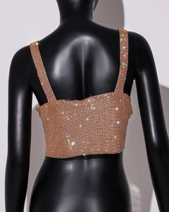 Rear view of cropped rhinestone top in rose gold with wide straps on a black model