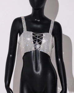 Detail of silver rhinestone crop top with criss-cross metal chains on a black mannequin