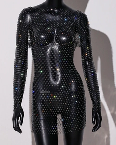 Detailed close-up of shiny multicolored rhinestones on black mesh long sleeve dress