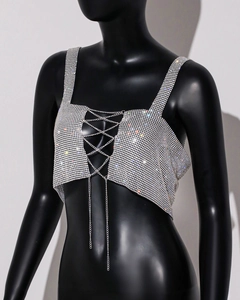 Detail of silver rhinestone crop top with criss-cross metal chains on a black mannequin