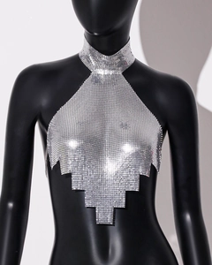 Close-up of sparkling silver metal mesh halter top with sequin fringe detail