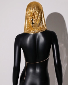 Detail of gold metal mesh chainmail hood featuring glossy sequins and adjustable back chain