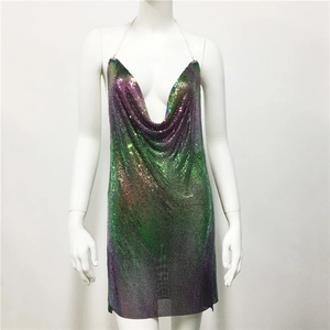 Detail view of iridescent green and purple metallic sequin mesh fabric with metal chains