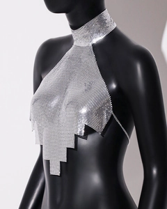 Detail of silver metallic sequin halter top featuring irregular geometric hem and chain links