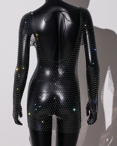 Detail of the open back on a black mesh dress with glittering rhinestones and neck tie