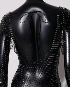 Detail of backless mesh dress featuring sparkling rhinestones and delicate tie-up design