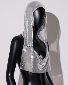Detail view of silver metal sequin hooded top showing chainmail texture and backless design