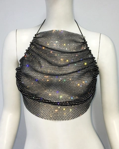 Macro view of crystal rhinestones on black mesh fabric of the halter neck crop top