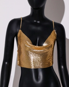 Detailed view of the gold metallic sequin mesh fabric and thin chain straps on top