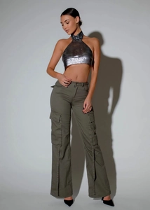Detail of silver metallic sequin halter crop top paired with olive cargo pants