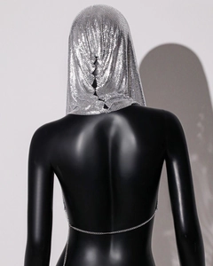 Detailed back view of metallic silver sequin mesh hooded vest with thin chain closure