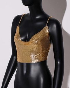 Detail of gold metal mesh crop top featuring a draped neckline and sequin texture